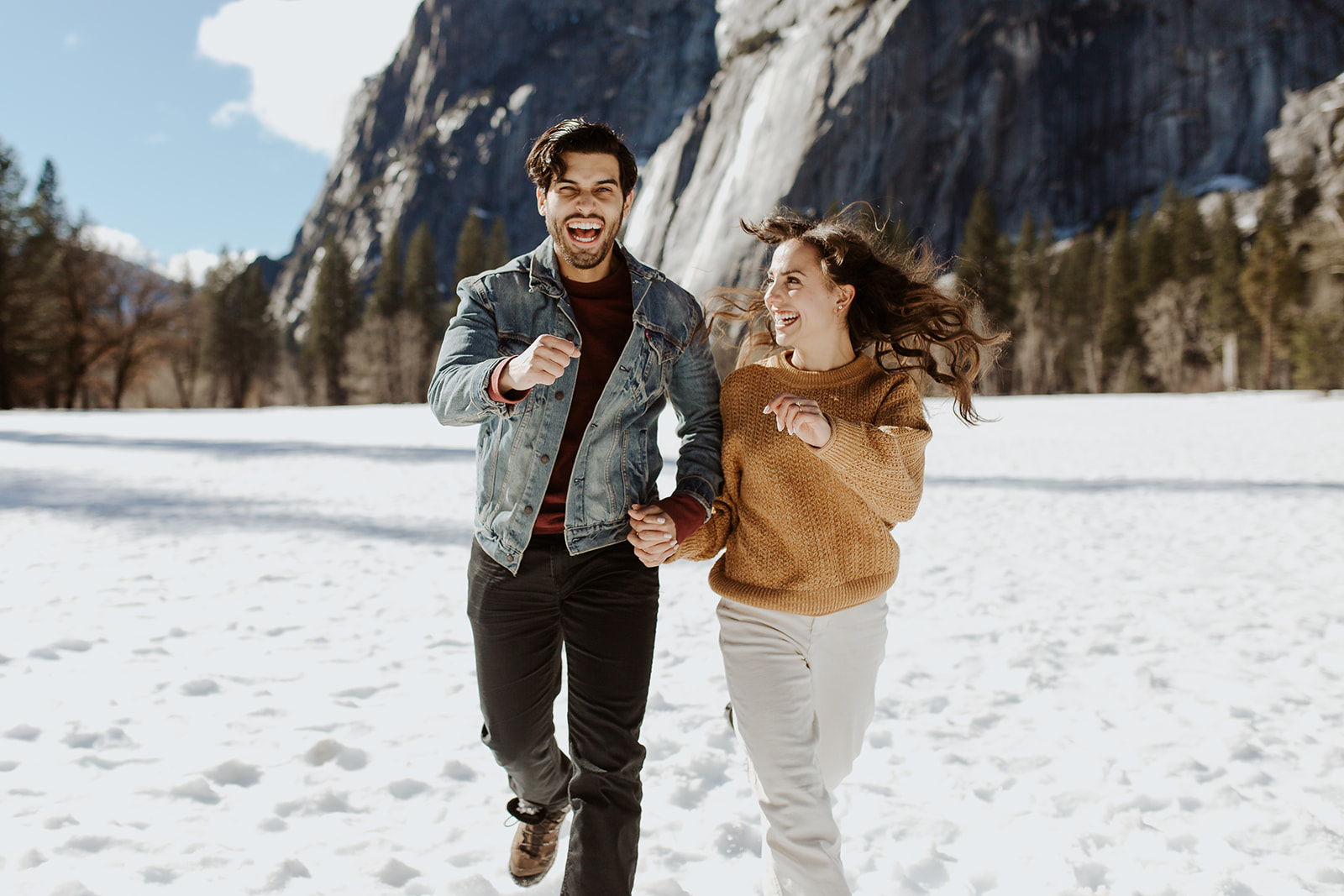 couple enjoys snow-capped mountains at Yosemite engagement session