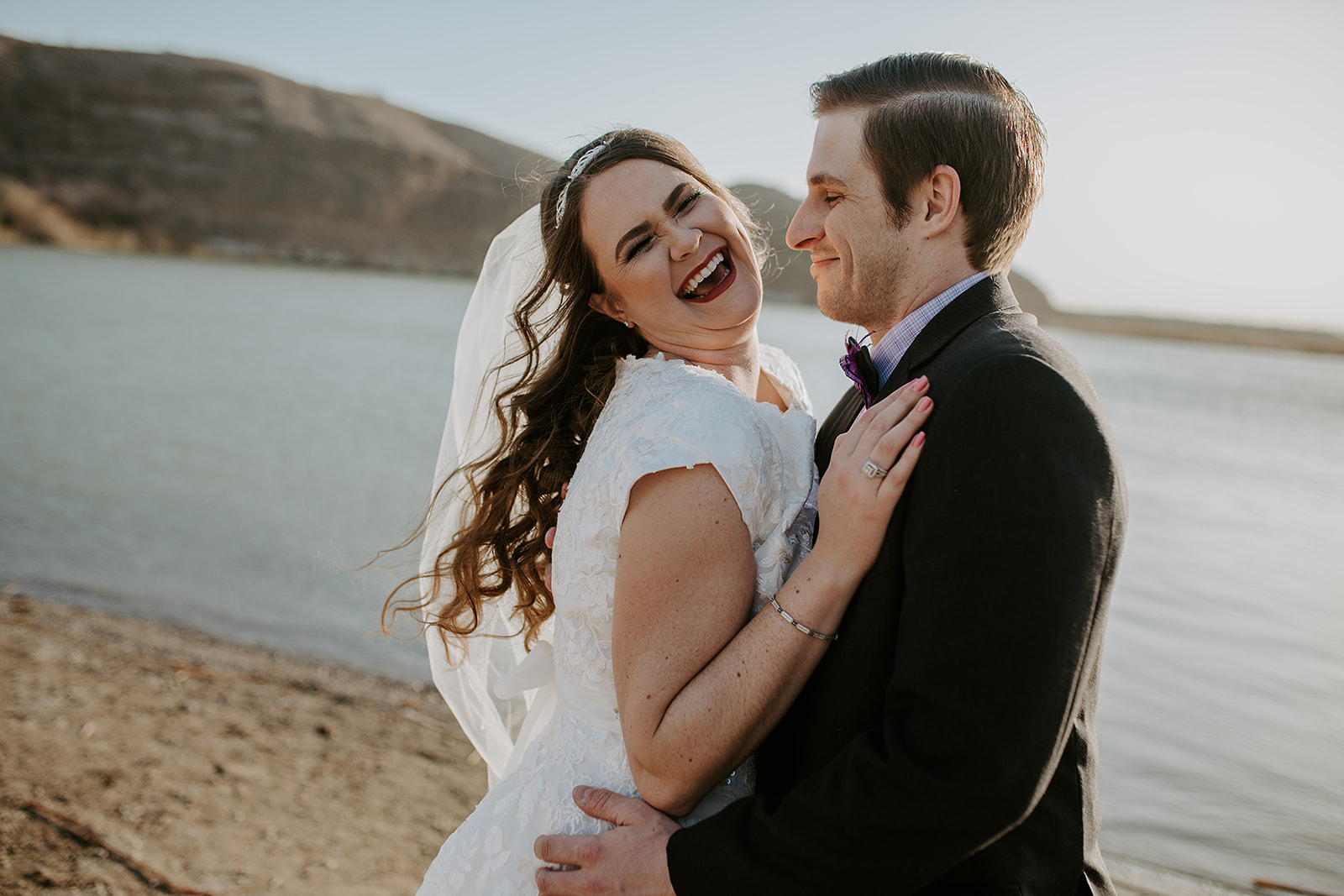 Candid laughing wedding photo of couple