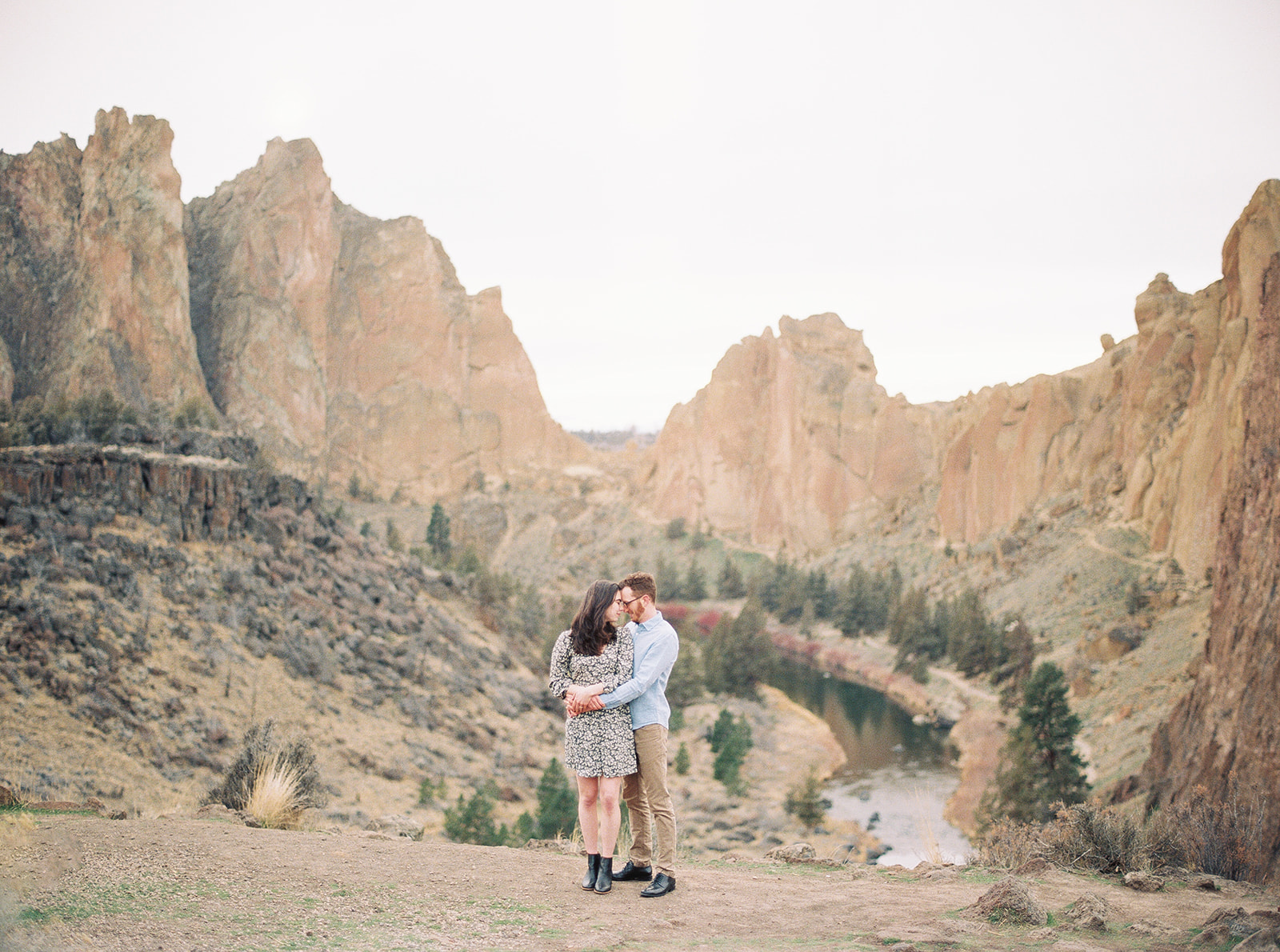 A couple enjoys the scenery with Smith Rock behind them