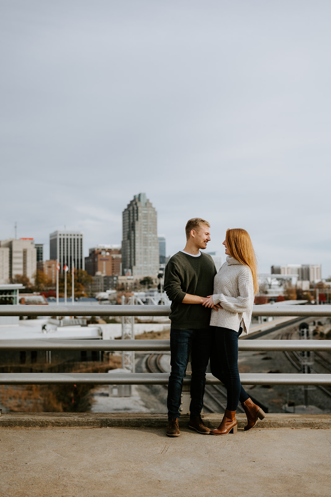Engaged couple on Boylan Bridge in Downtown Raleigh