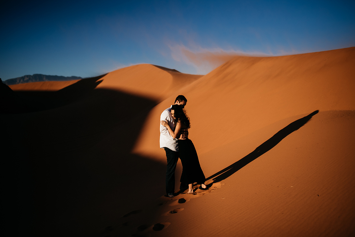 A couple stands out in Utah's red dunes, an image testament to emotive posing and bold editing