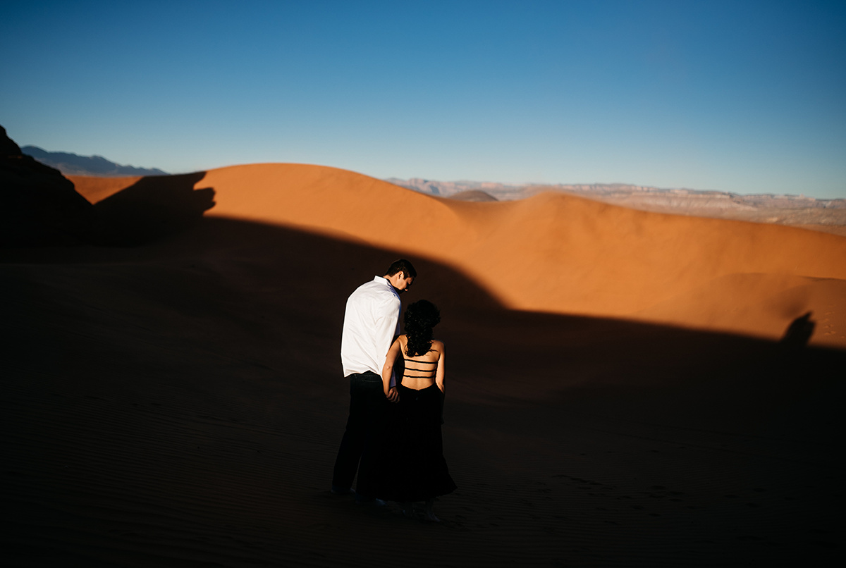 in Utah's red dunes, a couple paints a vivid picture of love, their emotions amplified by the backdrop