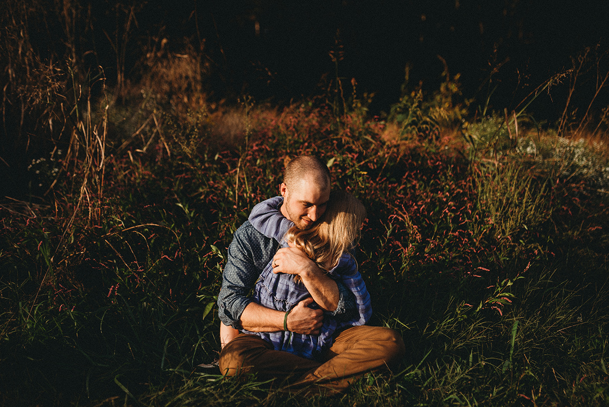 cinematic edit of a father and daughter sharing an emotive embrace sitting in tall grass