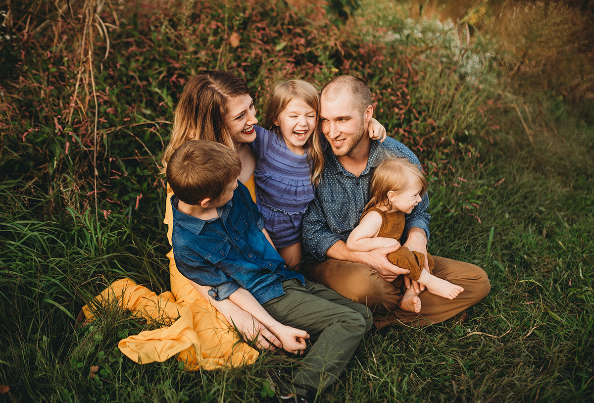 Family laughing together, embodying emotional storytelling in photography