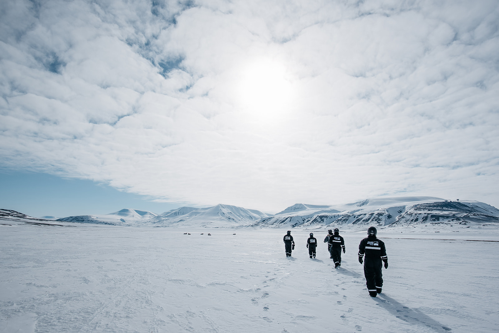 group exploring snowy landscape of Svalbard