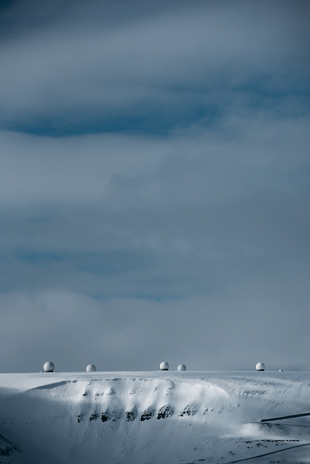 radar dishes on a snow covered mountain range on Svalbard