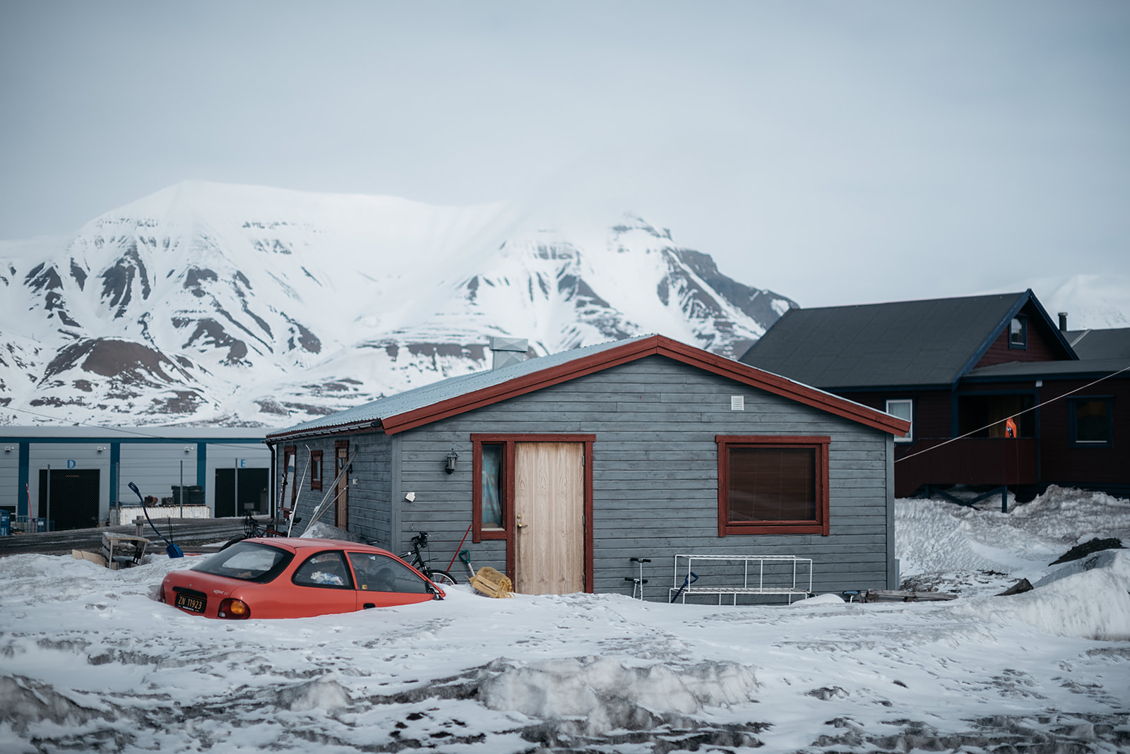 snow covered car in front of house on Svalbard