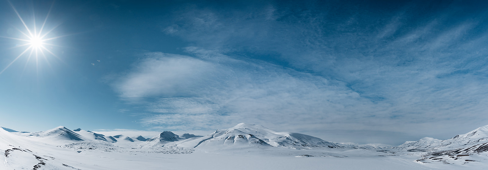 snow covered mountain range on a bright day on Svalbard